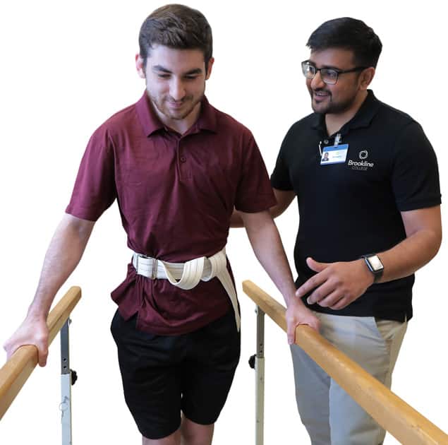 Physical therapy student getting hands-on practice with a patient