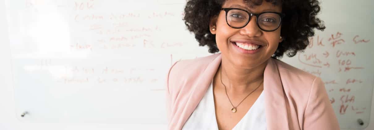 African-American woman in front of a whiteboard