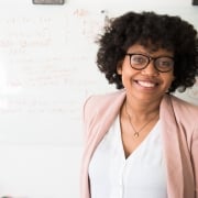African-American woman in front of a whiteboard