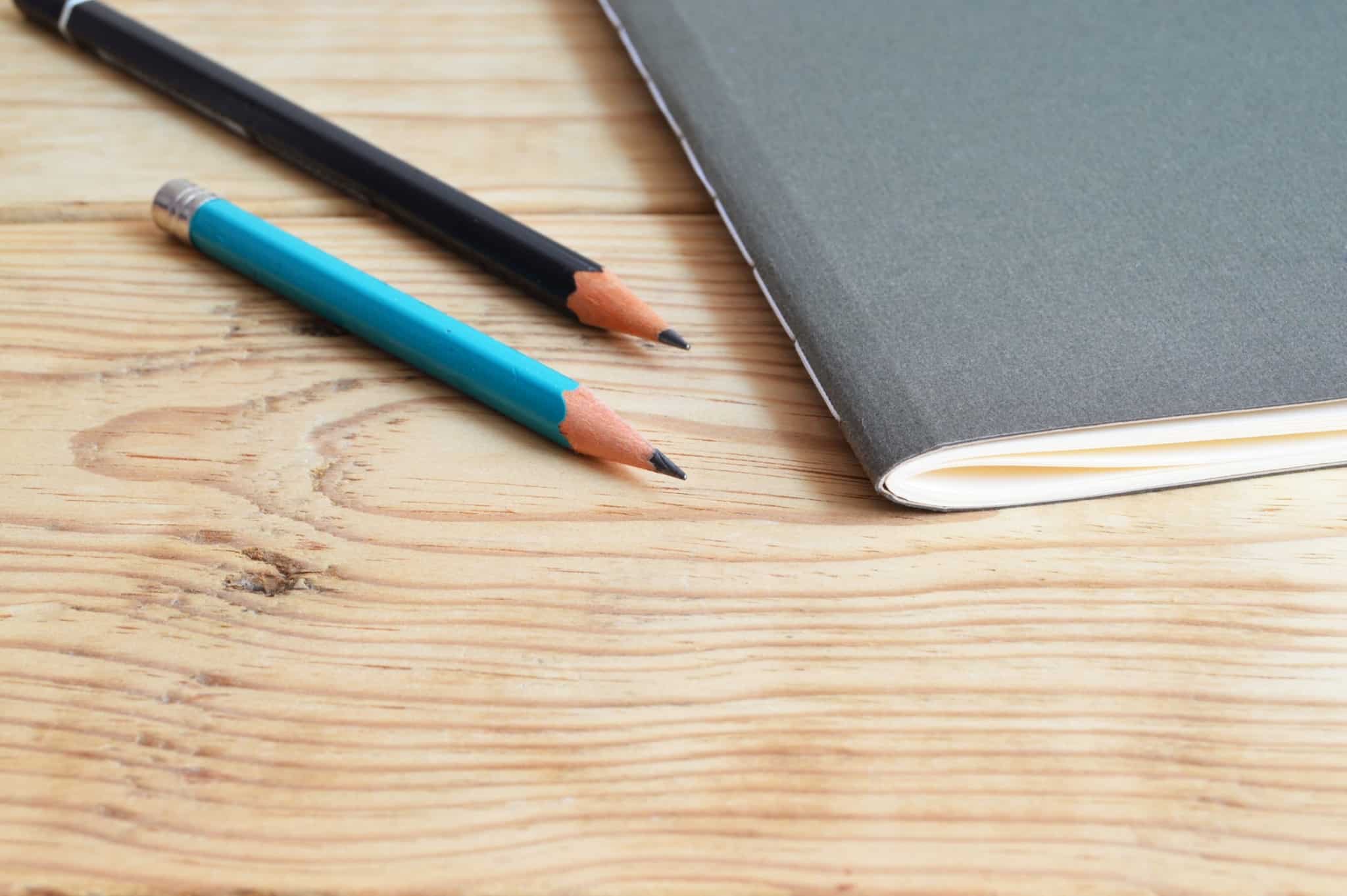 Close up of pencils and a notebook