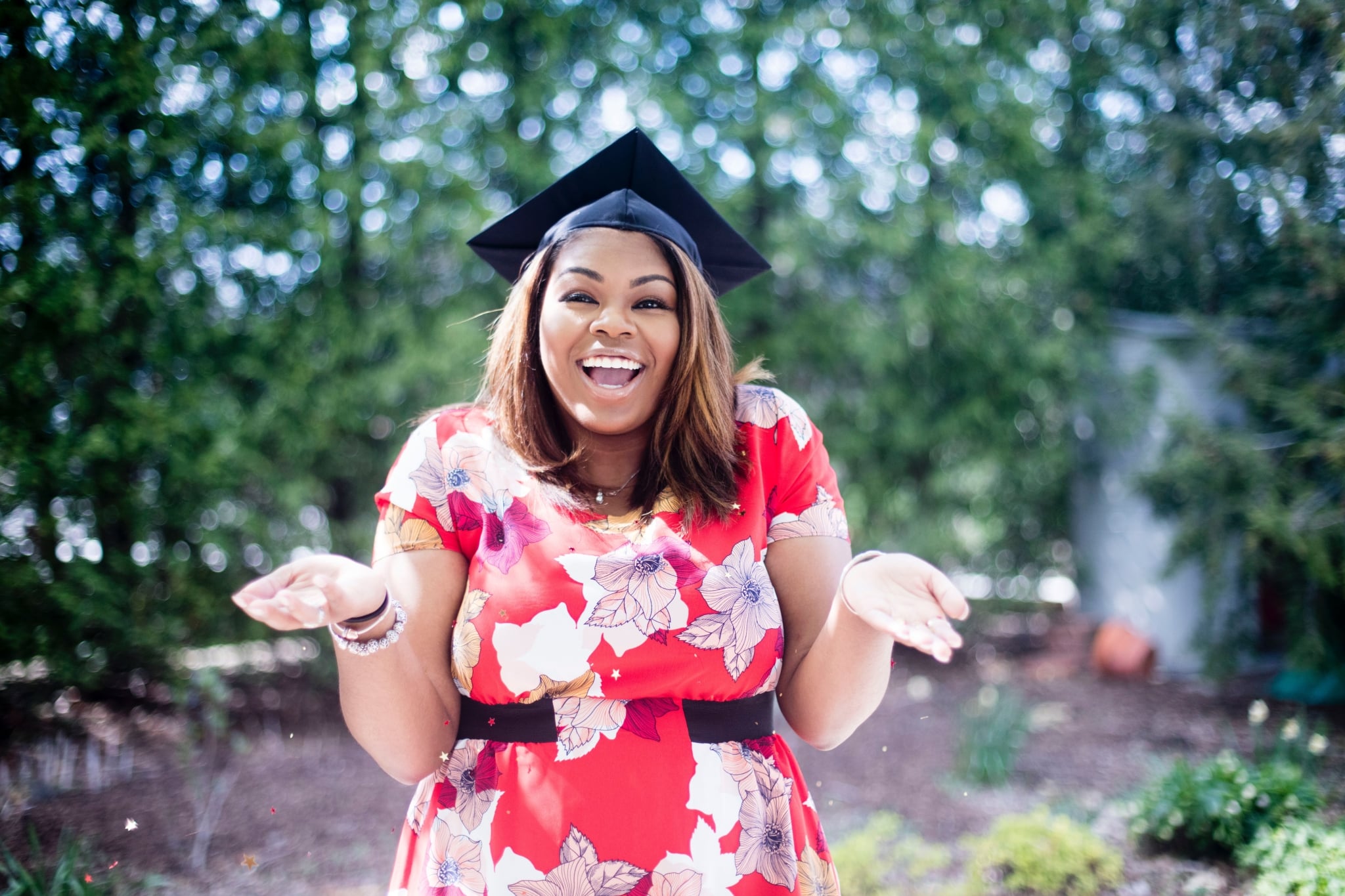 Smiling female graduate outdoors