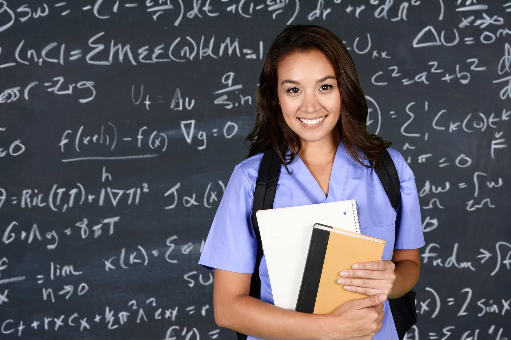 Female student in front of a blackboard