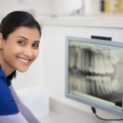 Smiling dental worker with an X-ray