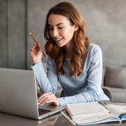 Mujer en un portátil tomando notas