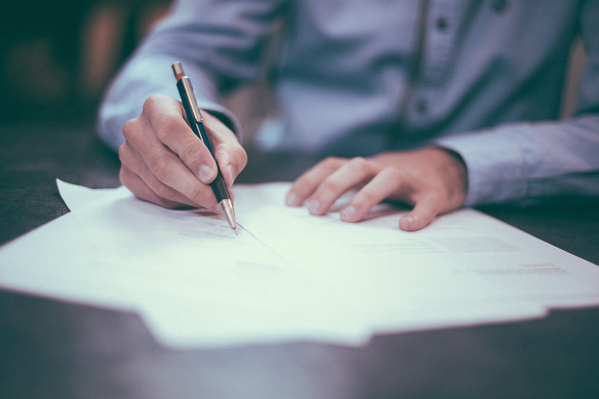 Close up of a man using pen and paper