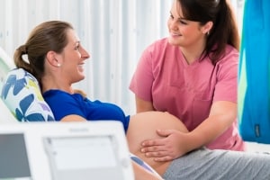 Midwife assisting a pregnant woman