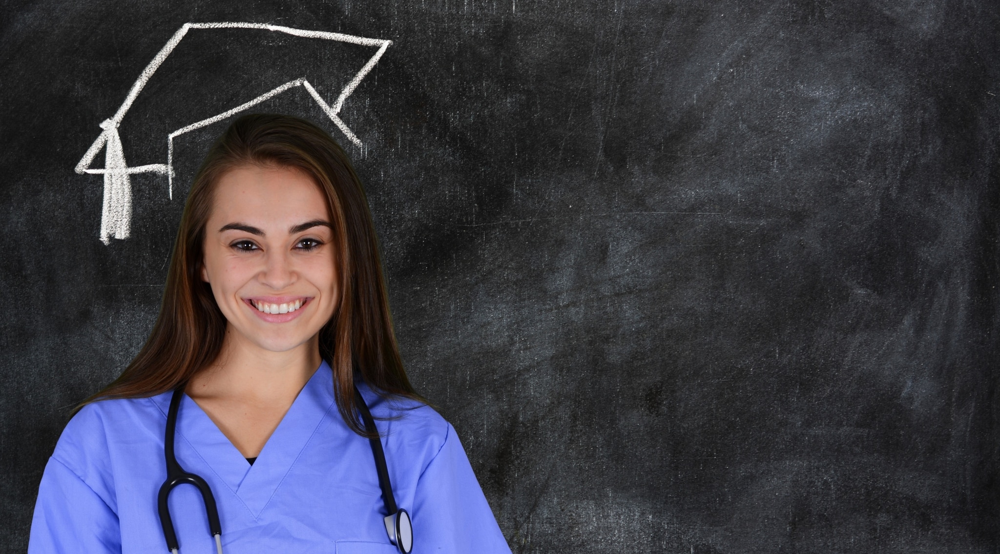 Nursing graduate in front of a blackboard
