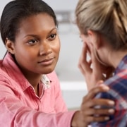 Healthcare professional consoling a patient