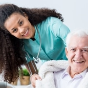 Smiling nurse with an elderly patient