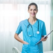 Smiling nurse with a stethoscope and clipboard