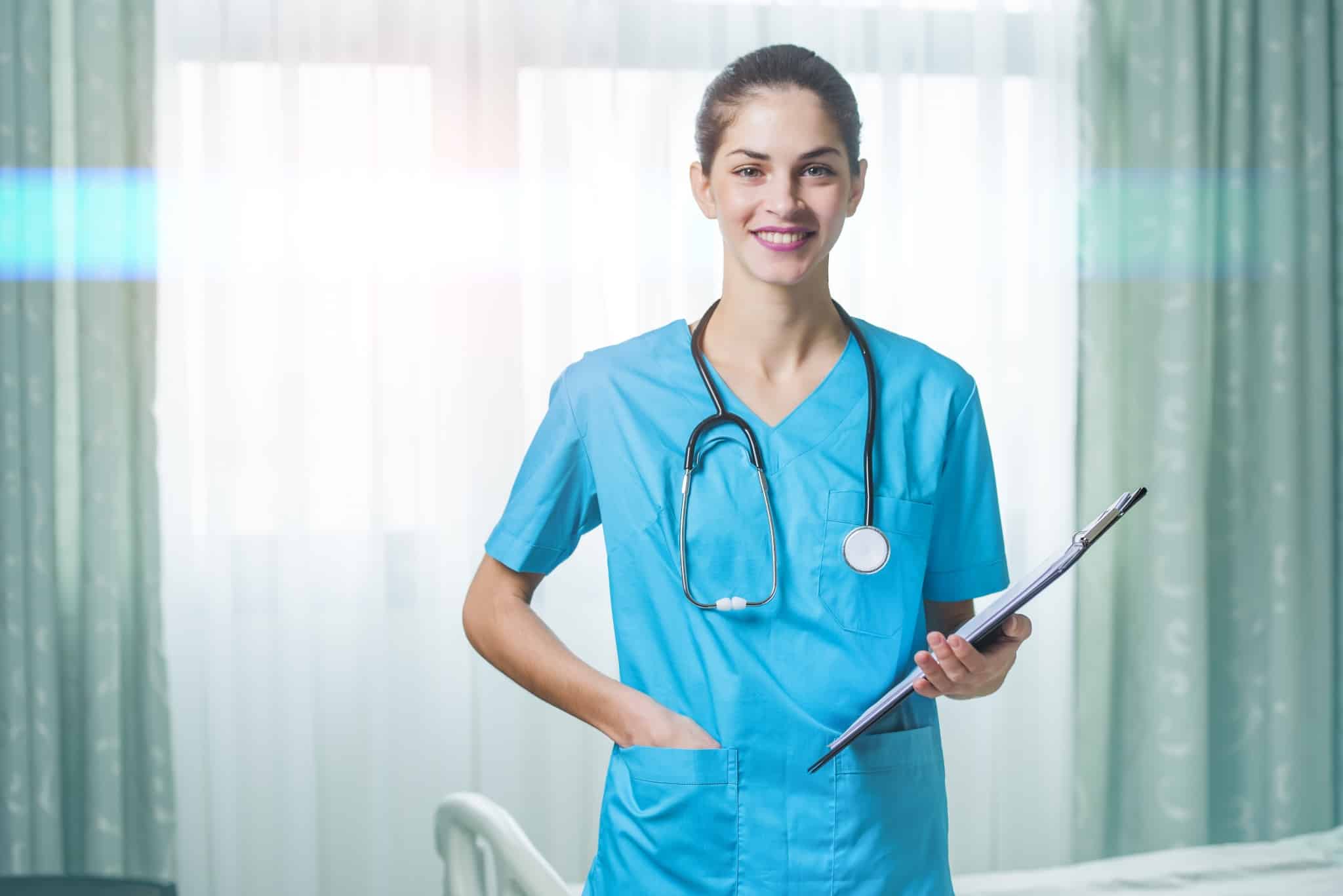 Smiling nurse with a stethoscope and clipboard