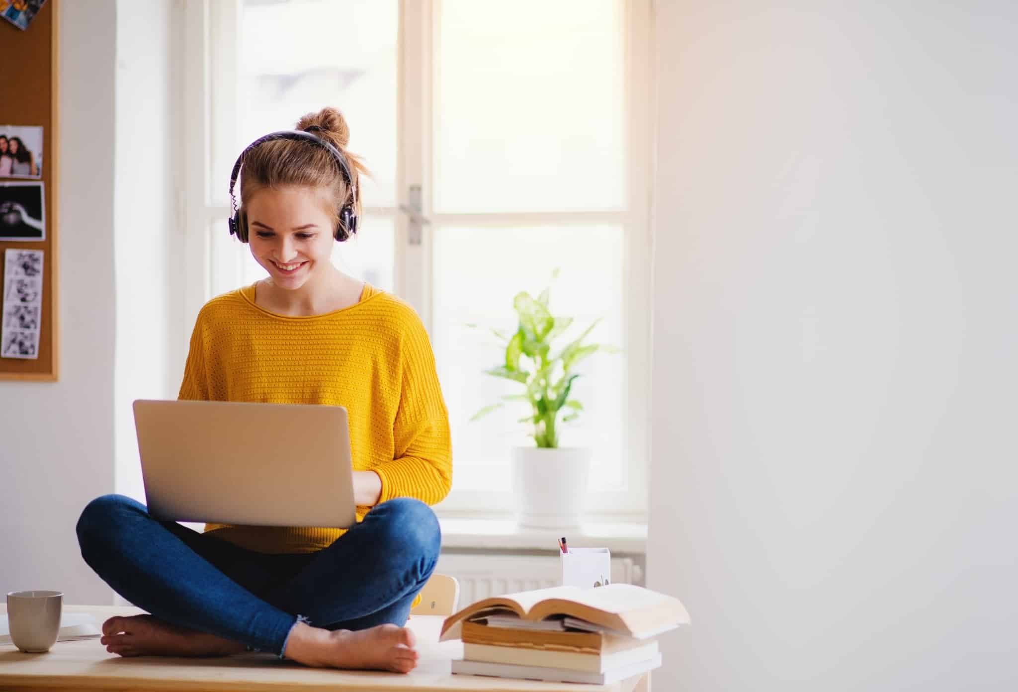 Woman in headphones on a laptop