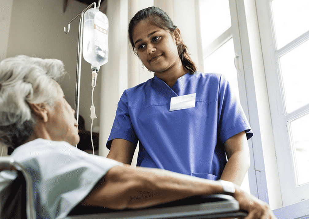 Female nurse assisting an elderly patient