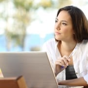 Woman with a pen and a laptop