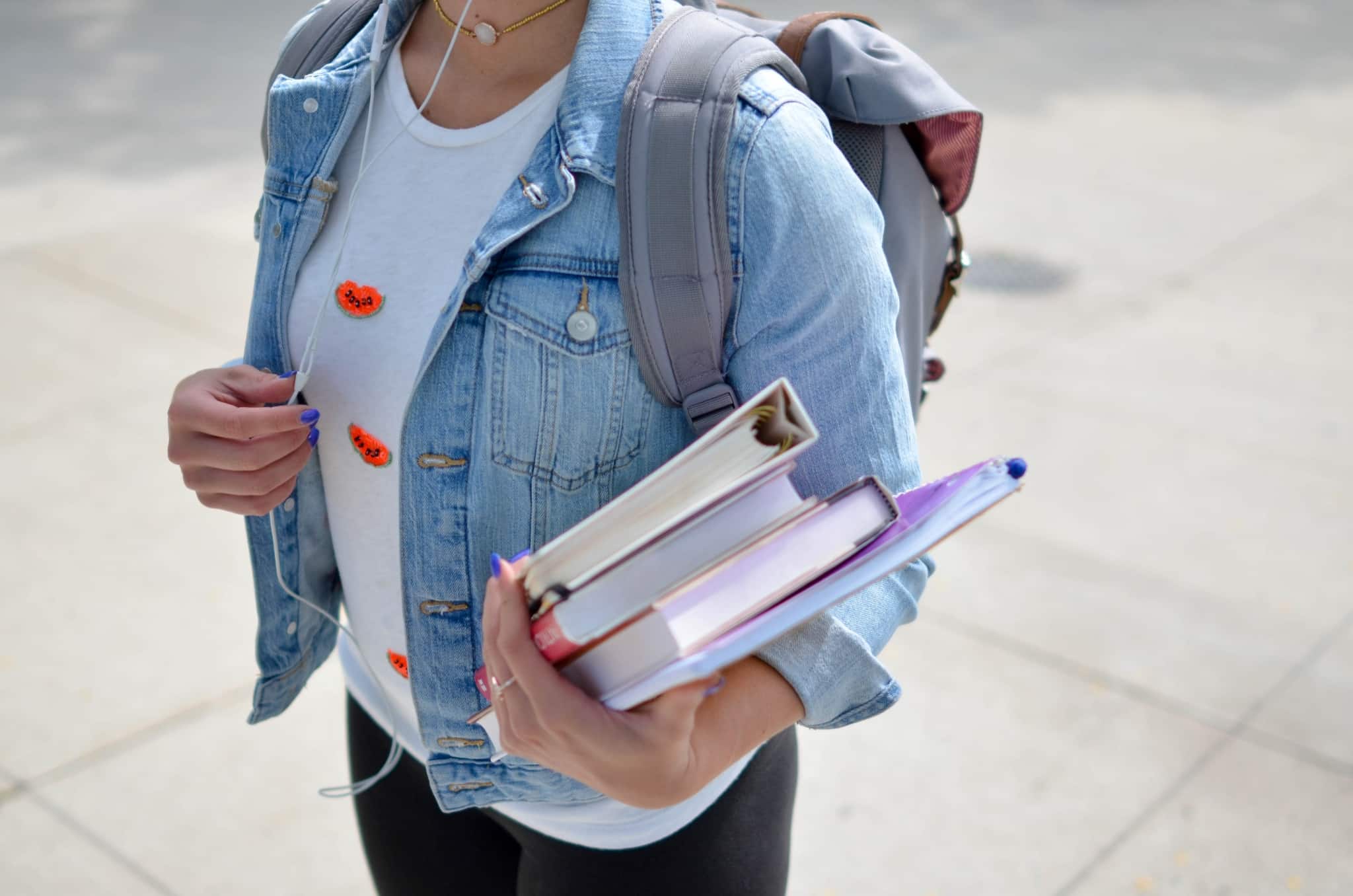 Woman with a backpack and books