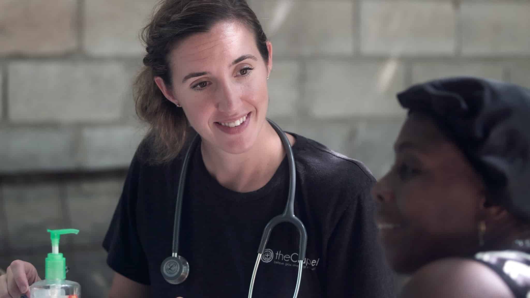 Smiling nurse with a female patient