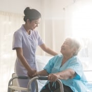 Medical professional smiling at elderly patient