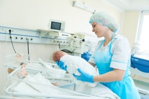 Neonatal nurse holding an infant