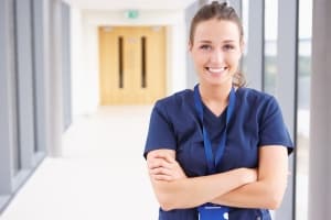 Smiling healthcare professional with arms crossed
