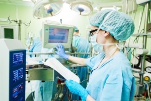 Surgical Technologist monitoring equipment