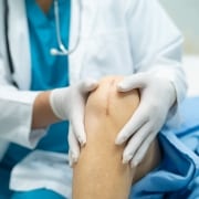 Healthcare professional examining stitches