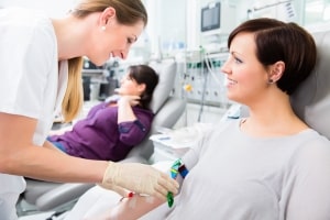 Healthcare professional performing a blood transfusion