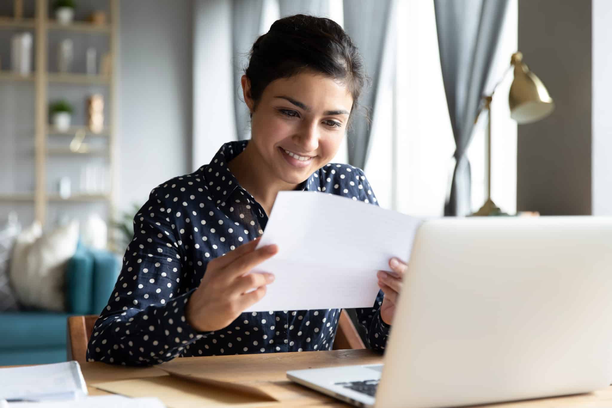 Smiling woman holding a piece of paper