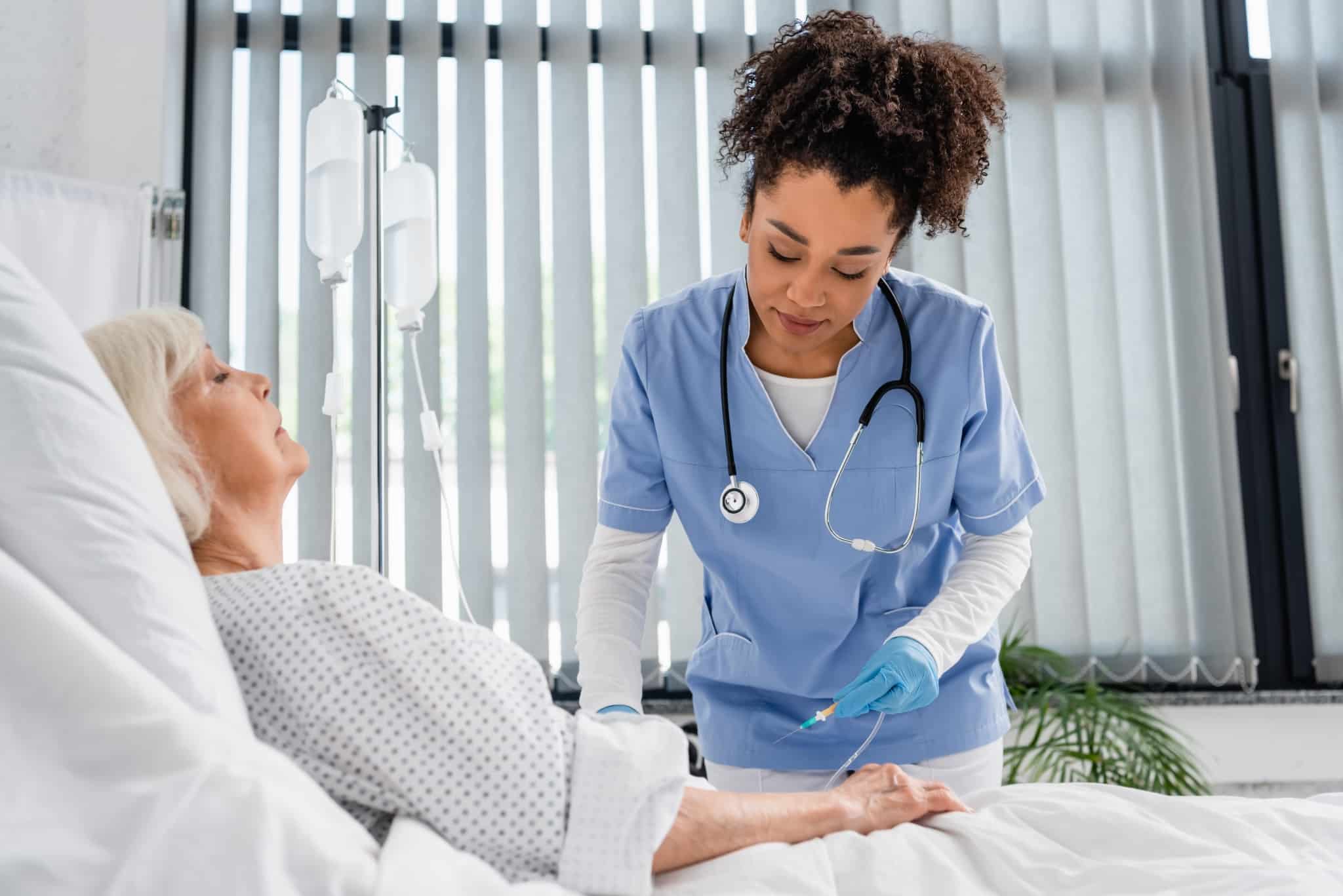 Nurse holding a catheter near a patient