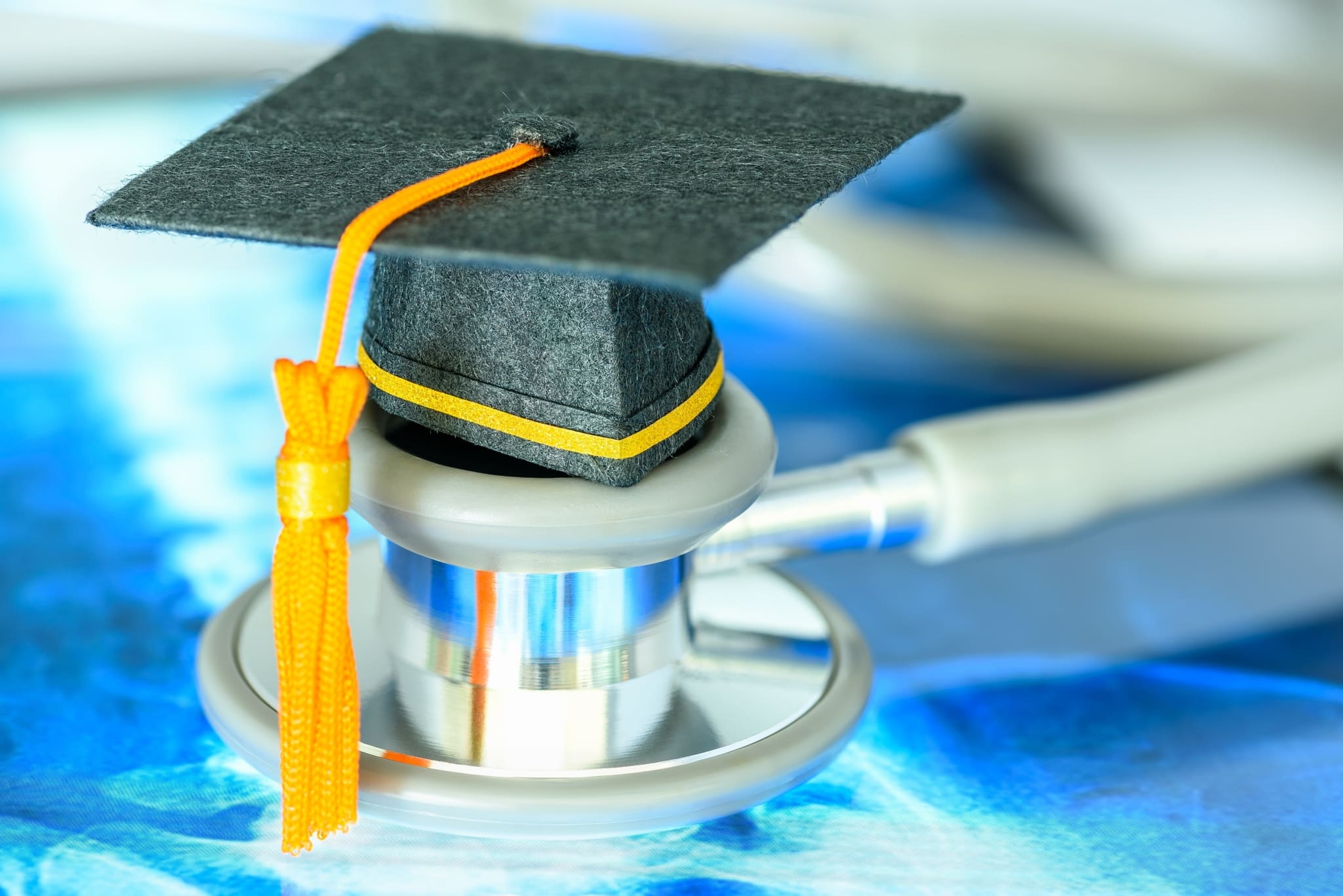 Mini graduate cap balanced on a stethoscope