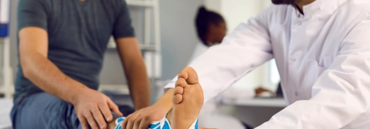 Medical professional examining a patient's ankle