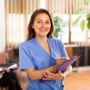 Confident nurse holding paperwork