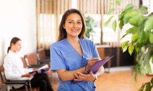 Confident nurse holding paperwork