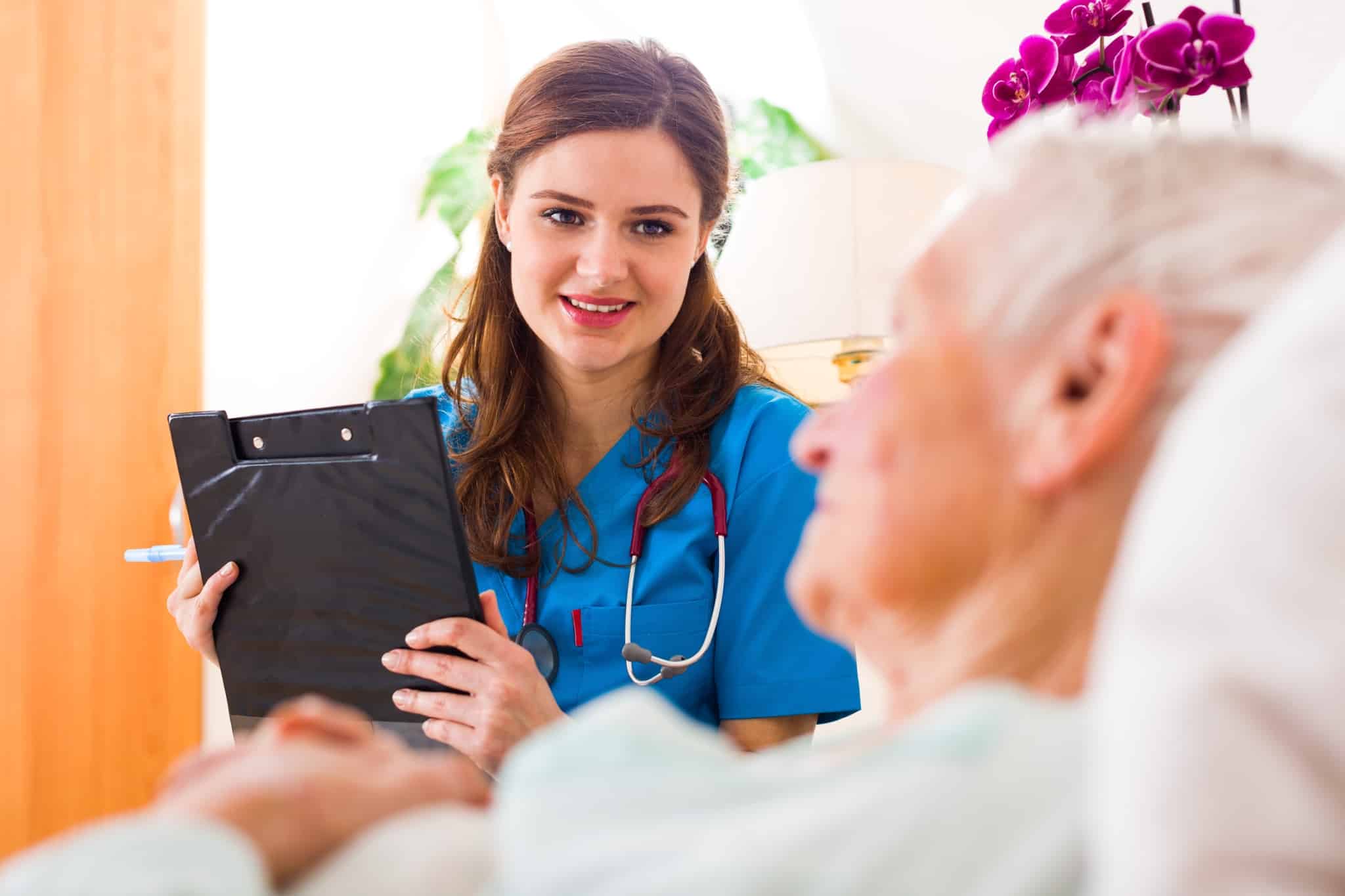 Nurse holding a clipboard with a patient