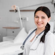 Healthcare worker in front of a hospital bed