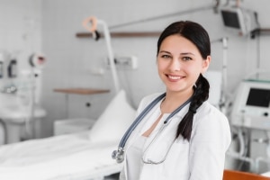 Healthcare worker in front of a hospital bed