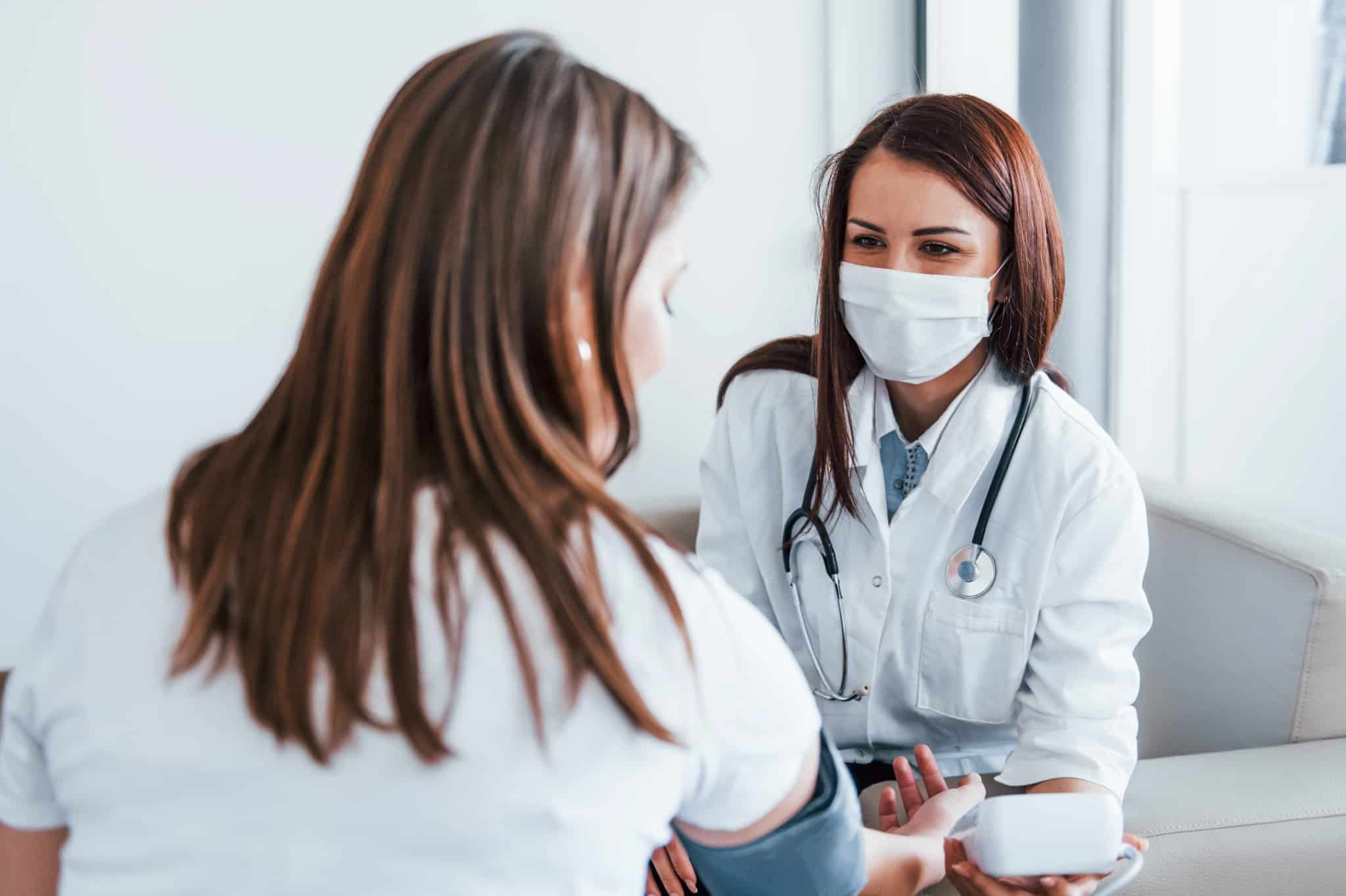 Female medical worker with a patient