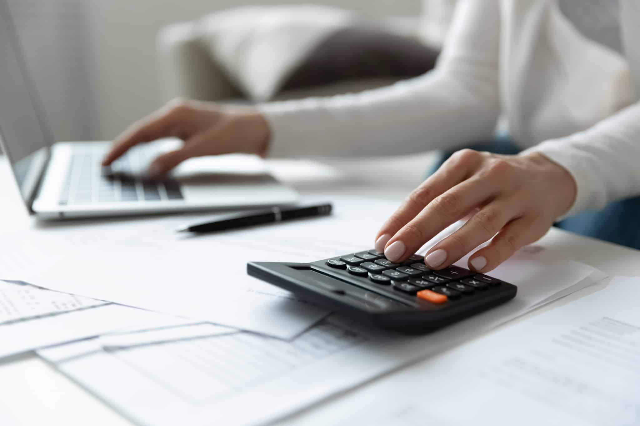 Close up of a woman using a calculator
