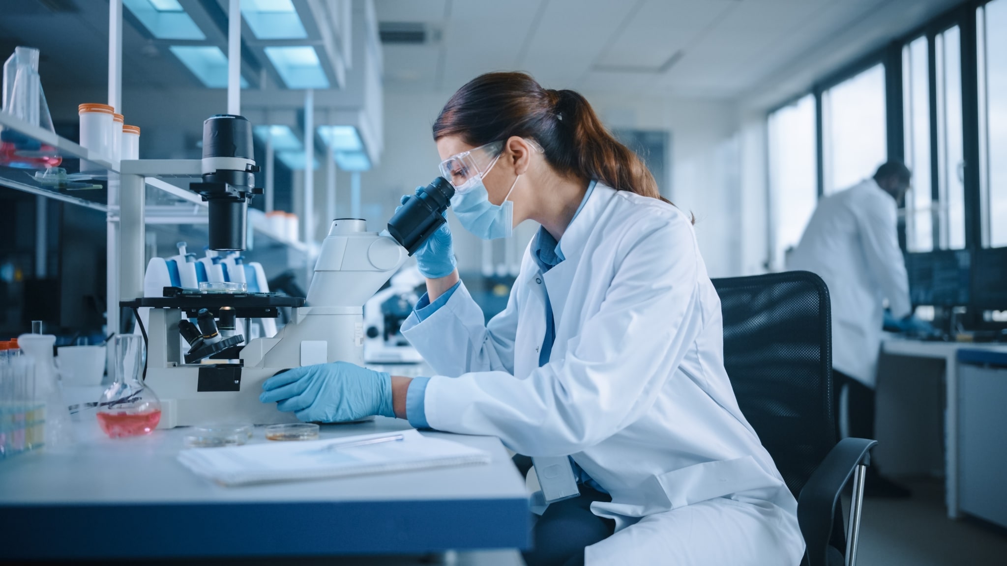 Female scientist looking in a microscope