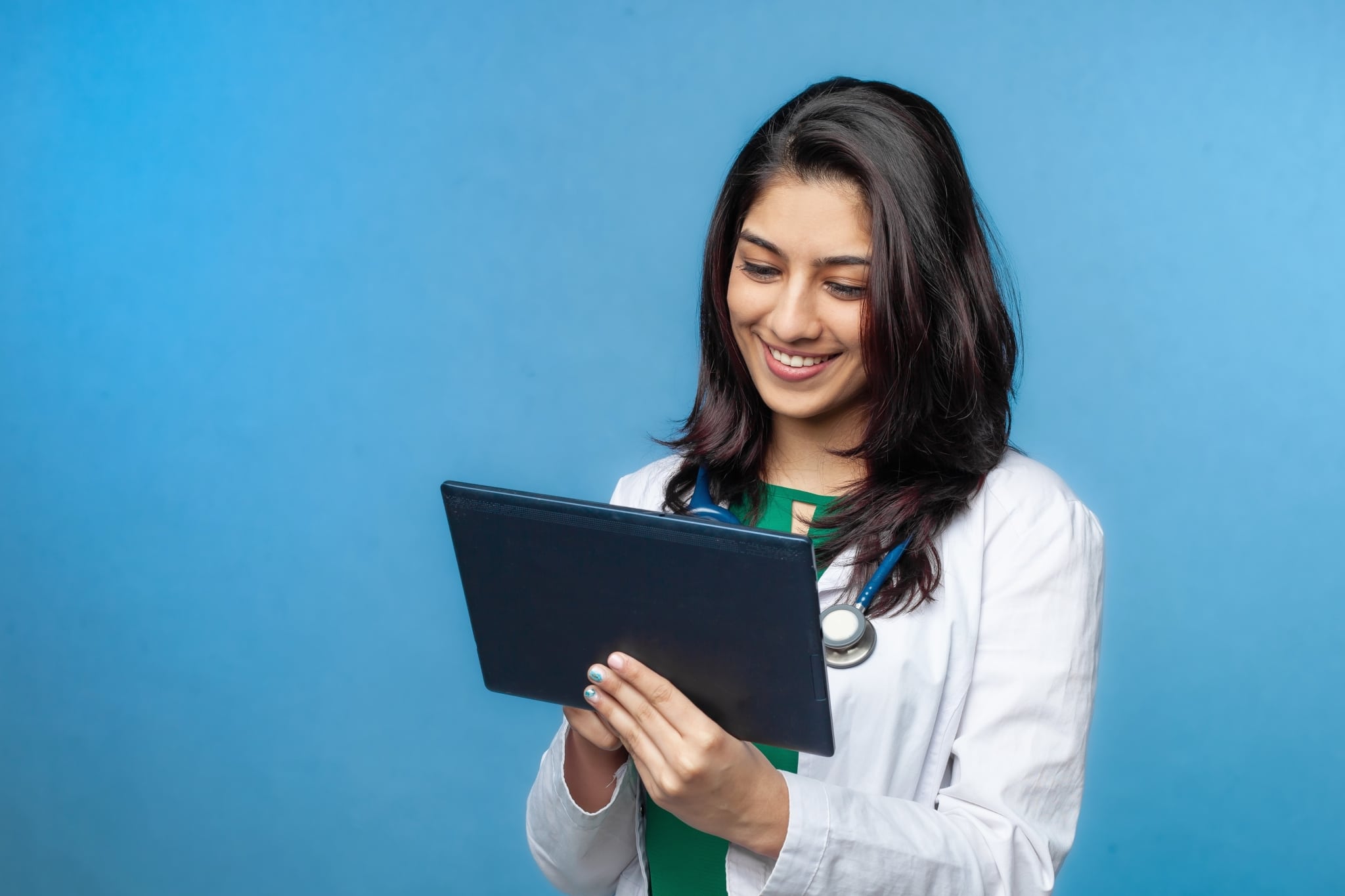 Young Asian medical professional using a tablet