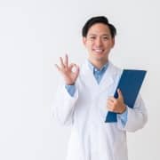 Asian man in a white coat holding a clipboard