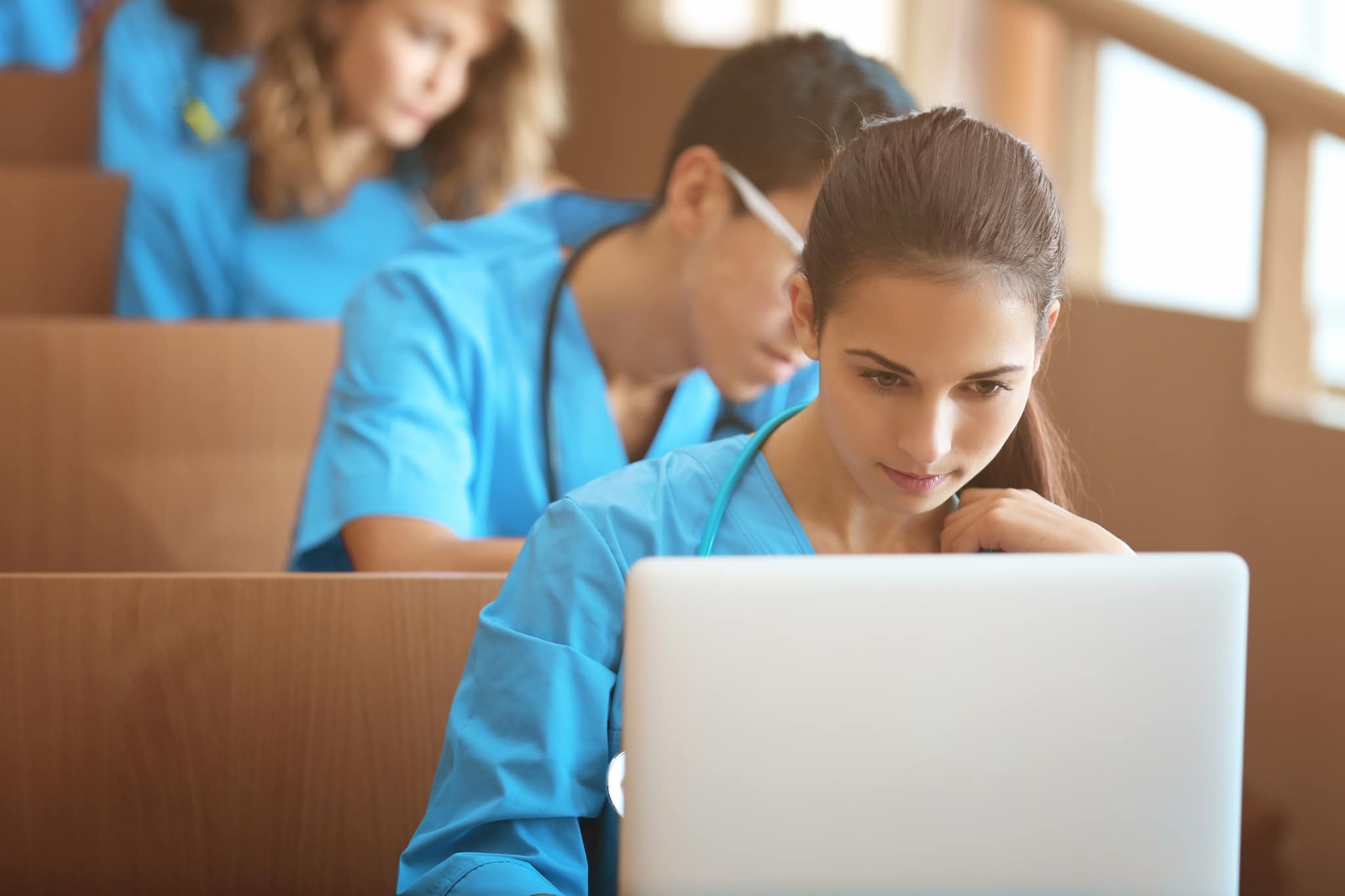 Medical students studying and using laptops