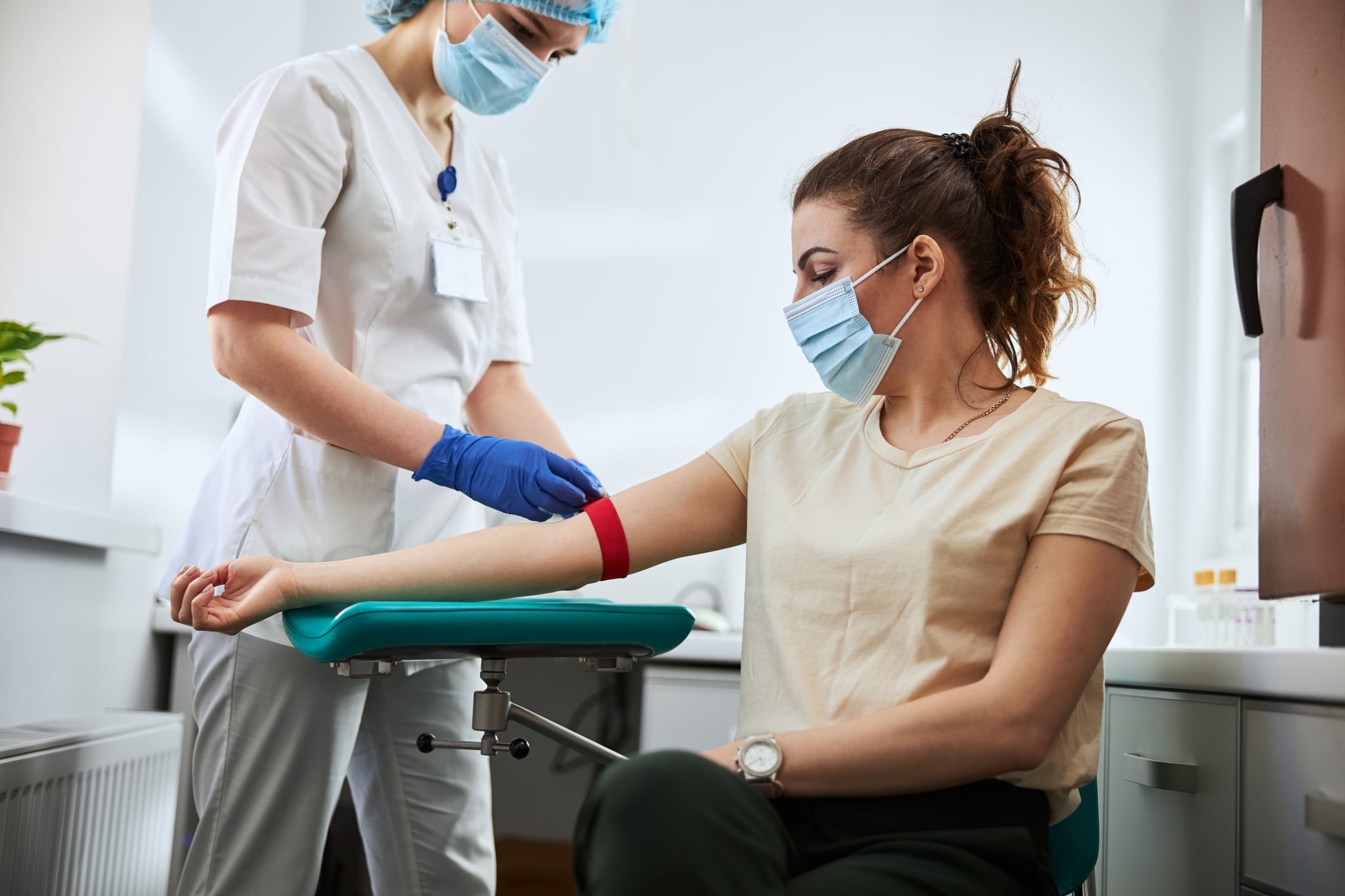 Phlebotomist drawing blood from a patient