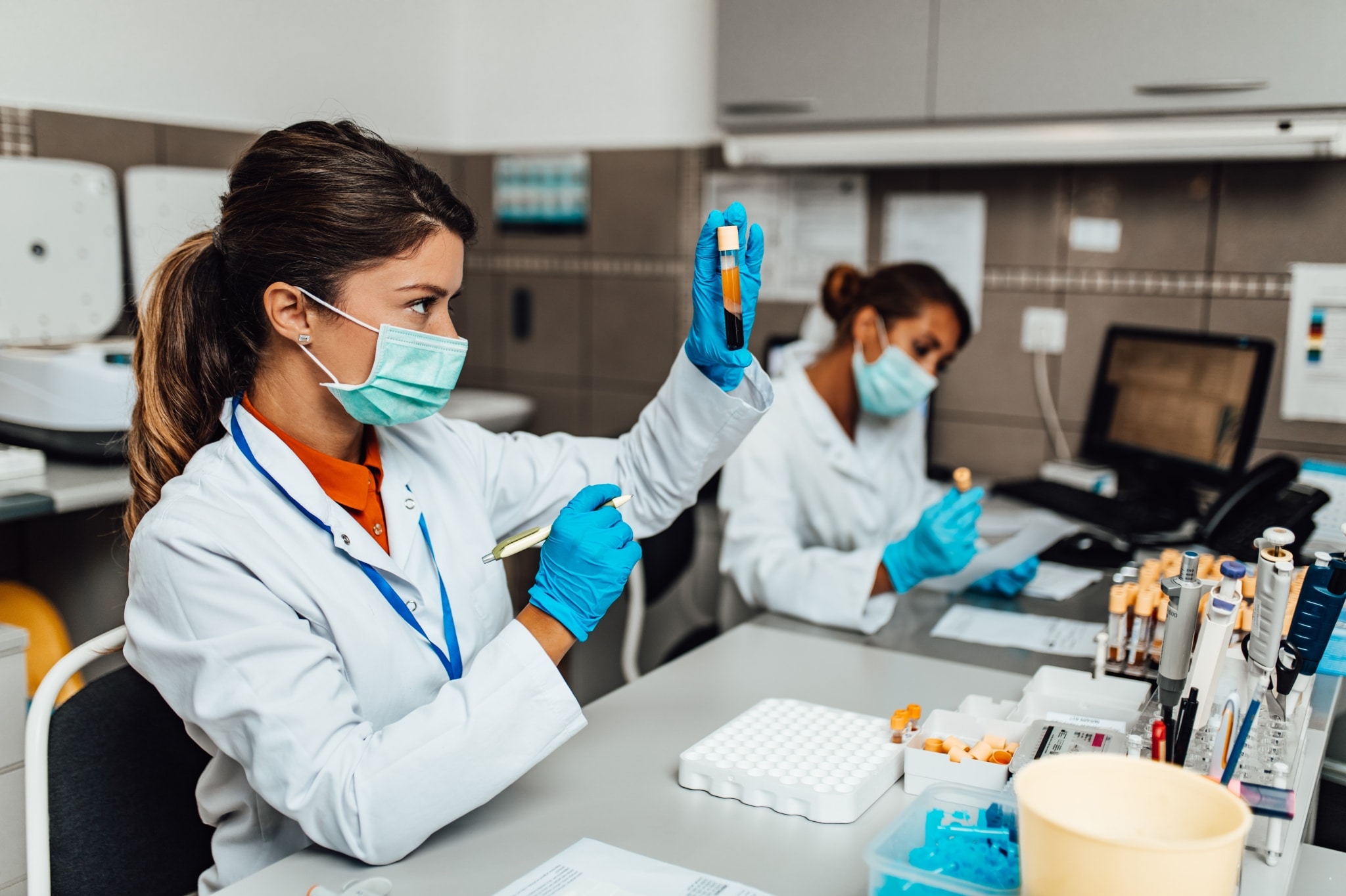 Two female lab technicians checking samples