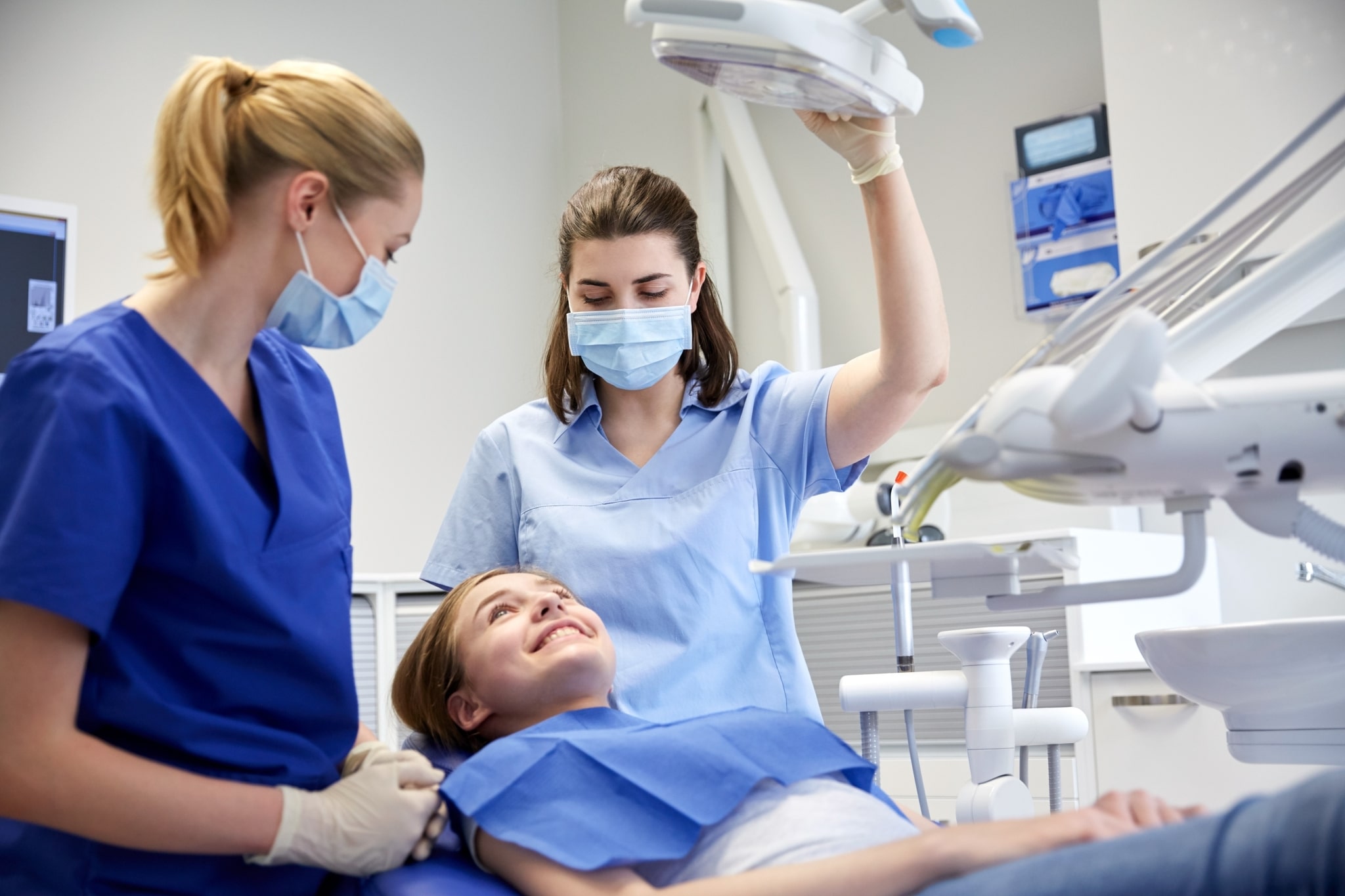 Hygienist with a dental assistant and patient