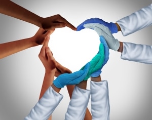 Healthcare workers forming a heart with their hands