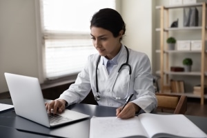 Serious young medical professional on a laptop