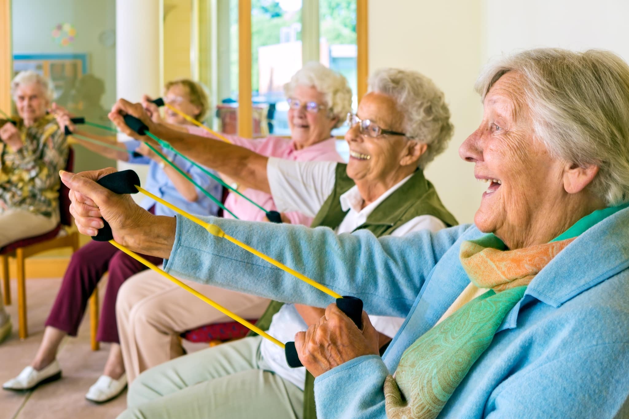 Group of happy seniors exercising together