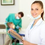 Close up of a dental professional with a clipboard