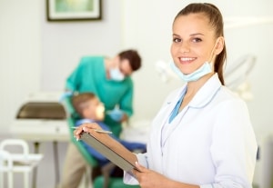 Close up of a dental professional with a clipboard