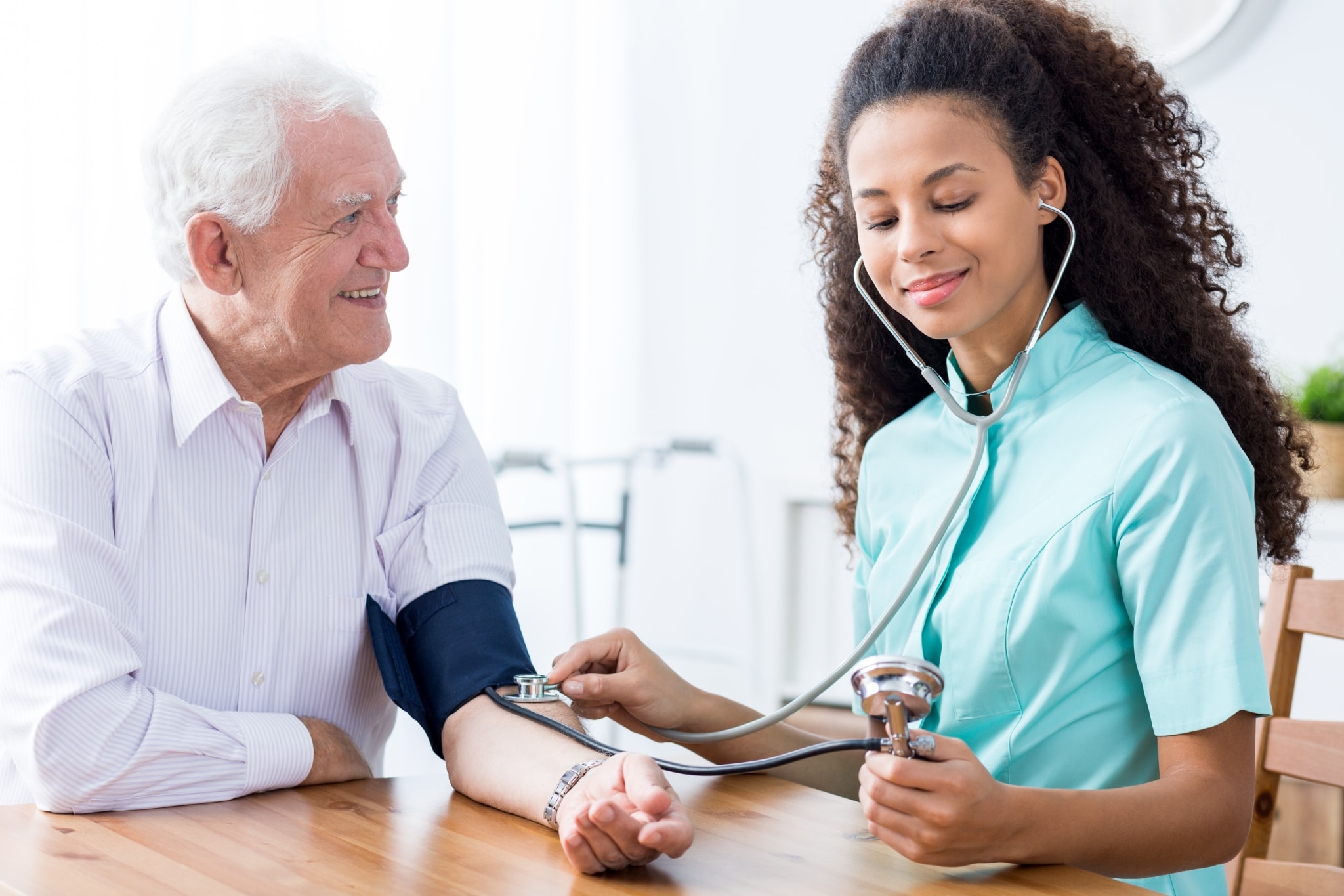 Young nurse checking a senior's vitals